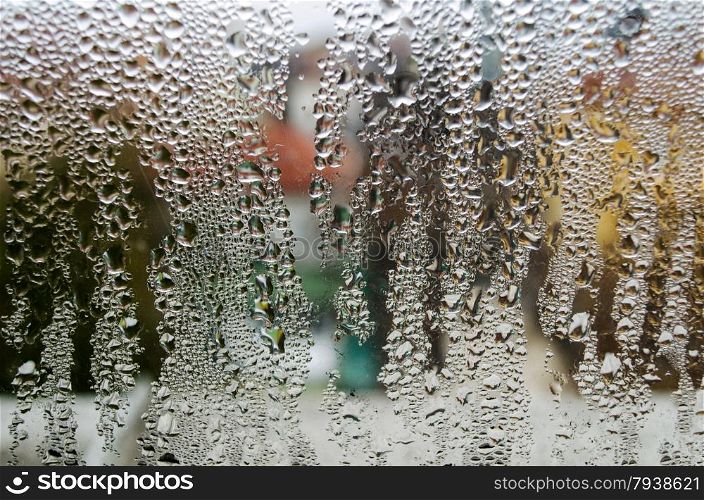 closeup of natural water drop on glass background