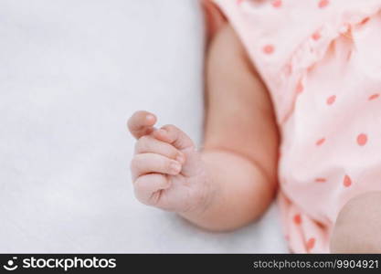 Closeup of newborn baby girl hand on white blanket outdoor. maternity and childhood concept. selective focus.. Closeup of newborn baby girl hand on white blanket outdoor. maternity and childhood concept. selective focus