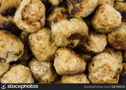 Closeup of newly fried meatballs all over