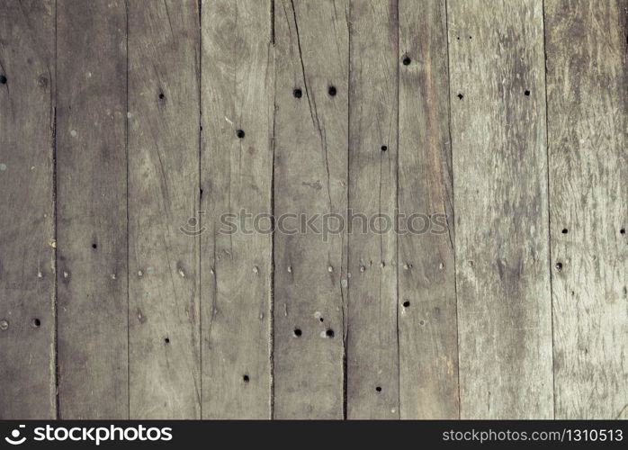 Closeup of old brown wooden plank texture background. Wallpaper backdrop. Abstract wood floor and wall structure. Top view angle. Vertical pattern