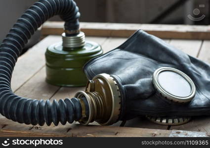 Closeup of old gas mask on wooden box