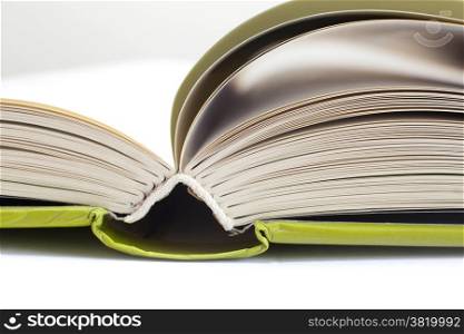 closeup of open book with green cover