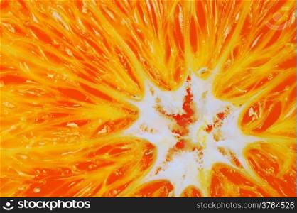 Closeup of orange fruit slice as food background or texture. Diet and healthy nutrition. Macro.