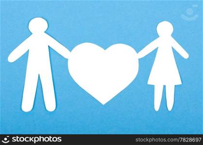 Closeup of paper people with a big heart on white background
