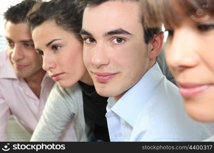 Closeup of people&rsquo;s faces in an office