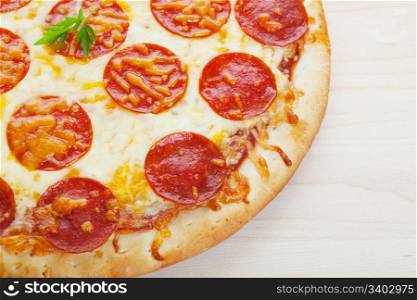Closeup of pepperoni pizza on a wooden board.