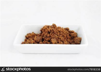 Closeup of pile of brown sugar in porcelaine bowl