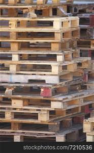 closeup of pile of empty wooden pallets form abstract composition