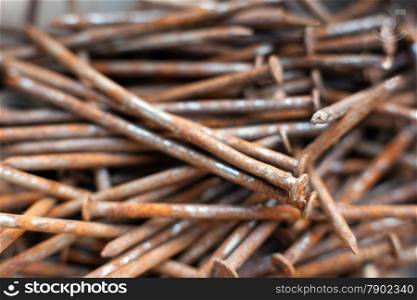 closeup of pile of old and rusty nails