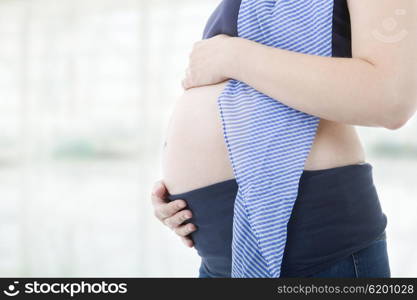 Closeup of pregnant woman at white background