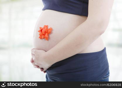 Closeup of pregnant woman at white background