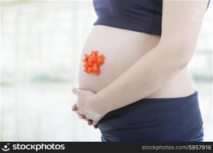 Closeup of pregnant woman, isolated on white