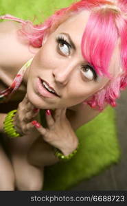 Closeup of Pretty Woman with Pink Hair on Green Rug