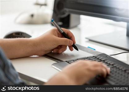 Closeup of professional graphic designer at work in office