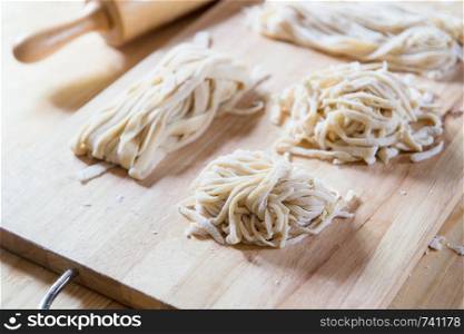 Closeup of raw noodle homemade on chopping block