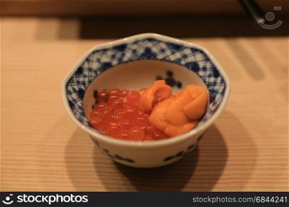 Closeup of raw sea urchin and salmon roe serve in small bowl