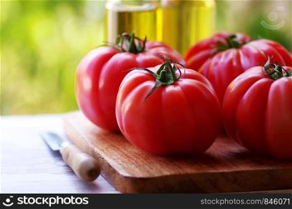 closeup of red tomatoes on wooden table