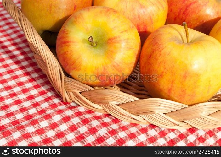 Closeup of Rubens Apples in Basket on Red Gingham Tablecloth