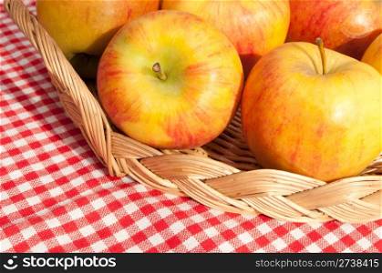 Closeup of Rubens Apples in Basket on Red Gingham Tablecloth