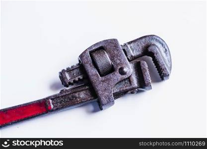 Closeup of rusted pipe wrench hand tool in isolated background