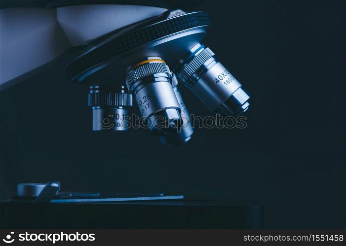 Closeup of Scientific microscope data analysis in the medical science laboratory, black background