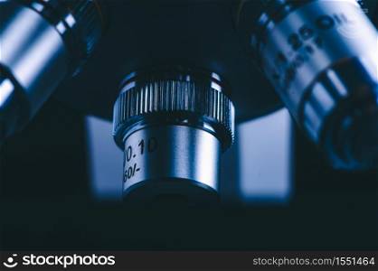 Closeup of Scientific microscope data analysis in the medical science laboratory, black background