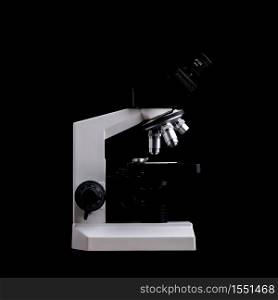 Closeup of Scientific microscope isolated on black, data analysis in the laboratory