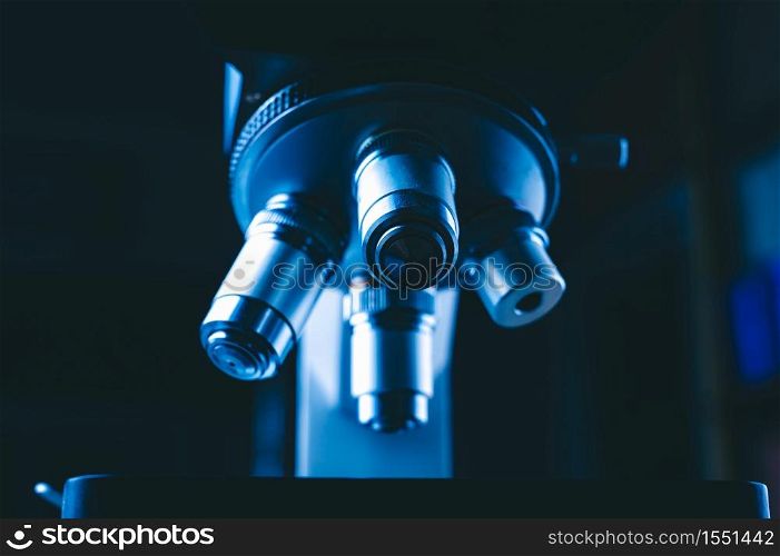 Closeup of Scientific microscope with metal lens in the laboratory, laboratory equipment - optical microscope.