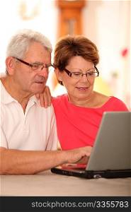 Closeup of senior couple doing online shopping