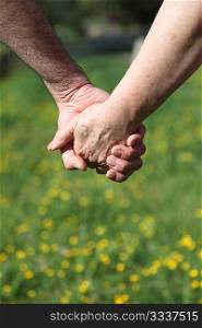Closeup of senior couple holding hands
