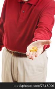Closeup of senior man&rsquo;s hand holding omega-3 fish oil capsules.