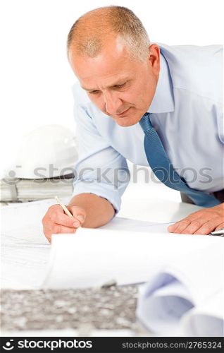 Closeup of senior man working on blueprints and construction plans