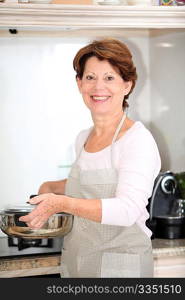 Closeup of senior woman standing in kitchen