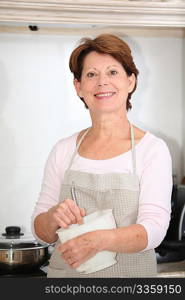 Closeup of senior woman standing in kitchen