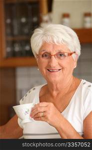 Closeup of senior woman with coffee cup
