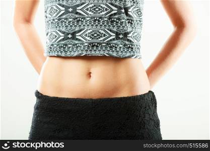 Closeup of sexy alluring woman hips and belly. Slim girl wearing black shorts shirt