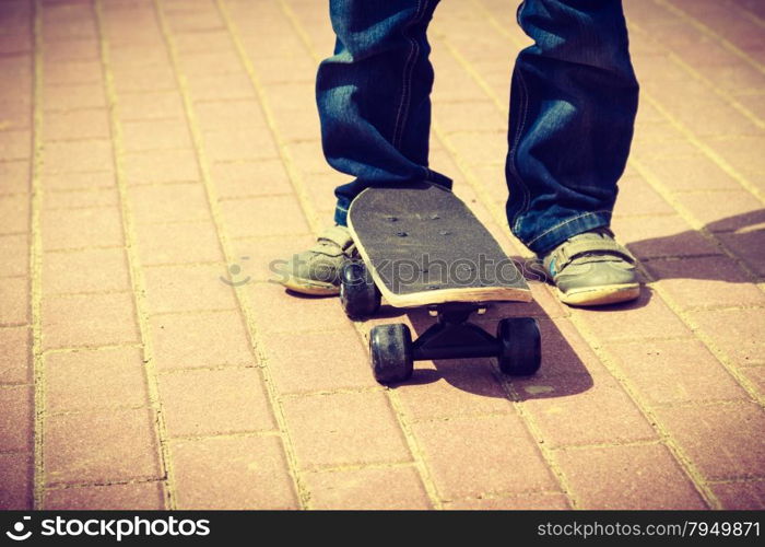 Closeup of skateboarder legs. Kid child riding skateboard outdoor. Active boy skateboarding on pavement sidewalk. Kid practicing outside. . Skateboarder legs closeup. Kid skateboarding.