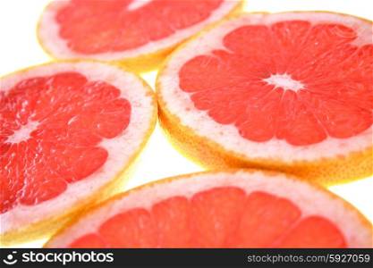 Closeup of sliced grapefruit on white background