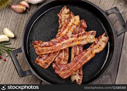Closeup of slices of crispy hot fried bacon. fried bacon