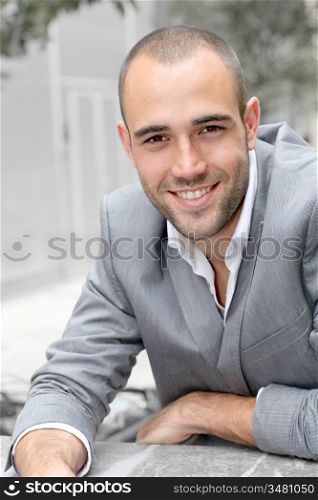 Closeup of smiling businessman in town