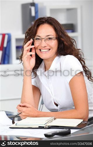 Closeup of smiling businesswoman wearing eyeglasses