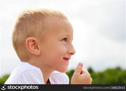 Closeup of smiling child kid outdoor. Happy childhood.. Happy smiling child kid outdoor.