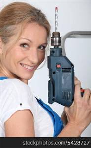 Closeup of smiling lady with electric drill