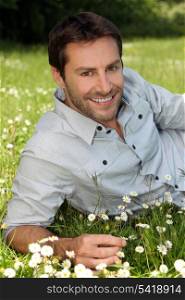 Closeup of smiling man amongst the daisies