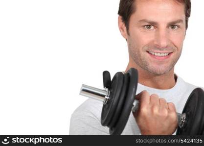 Closeup of smiling man with dumbbell