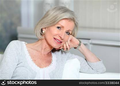 Closeup of smiling senior woman relaxing at home