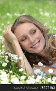 Closeup of smiling woman amongst the daisies