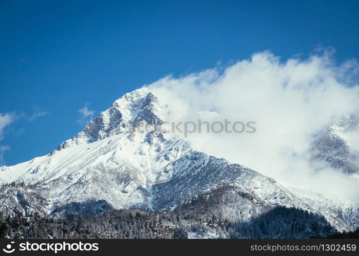 Closeup of snowy mountains and clouds in Austria