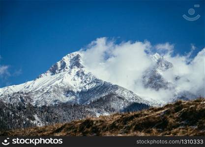 Closeup of snowy mountains and clouds in Austria