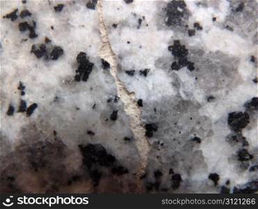closeup of some cracked granite as a background